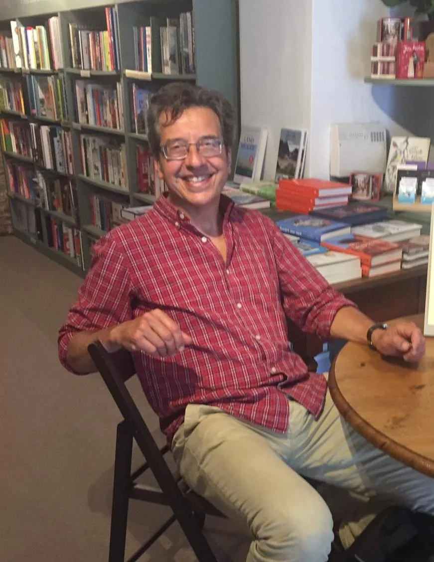 Author George Monbiot seated in The East Gate Bookshop during a signing visit