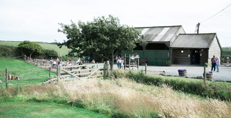 Stone and timber farm building with outdoor benches at East Soar
