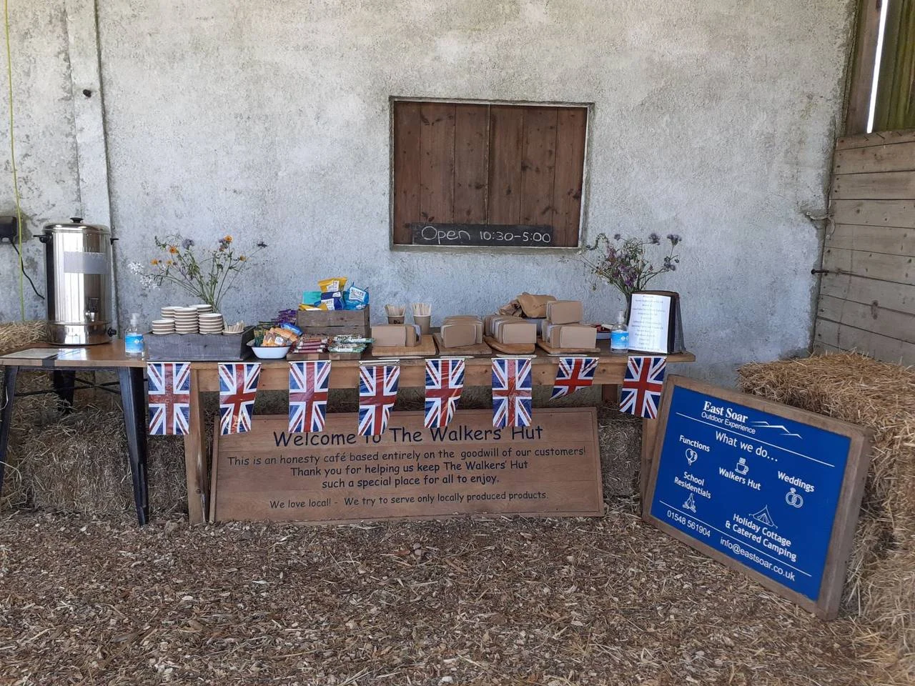 Self-service drinks and supplies on a table inside the hut