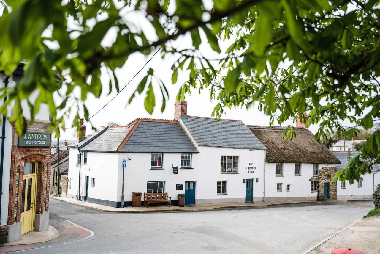 Whitewashed Farmers Arms pub on the village street