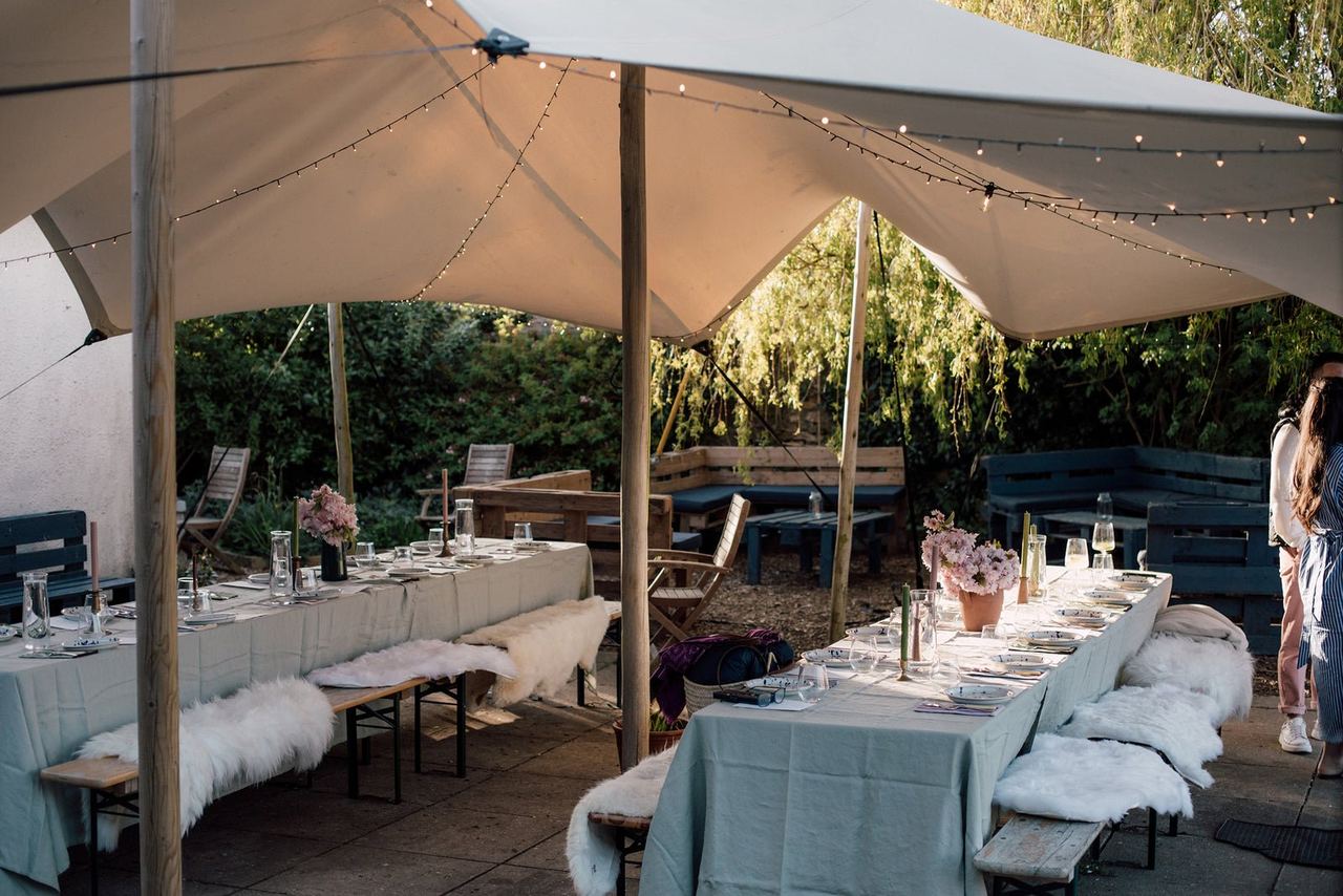 Long outdoor tables set for a Finns supper club
