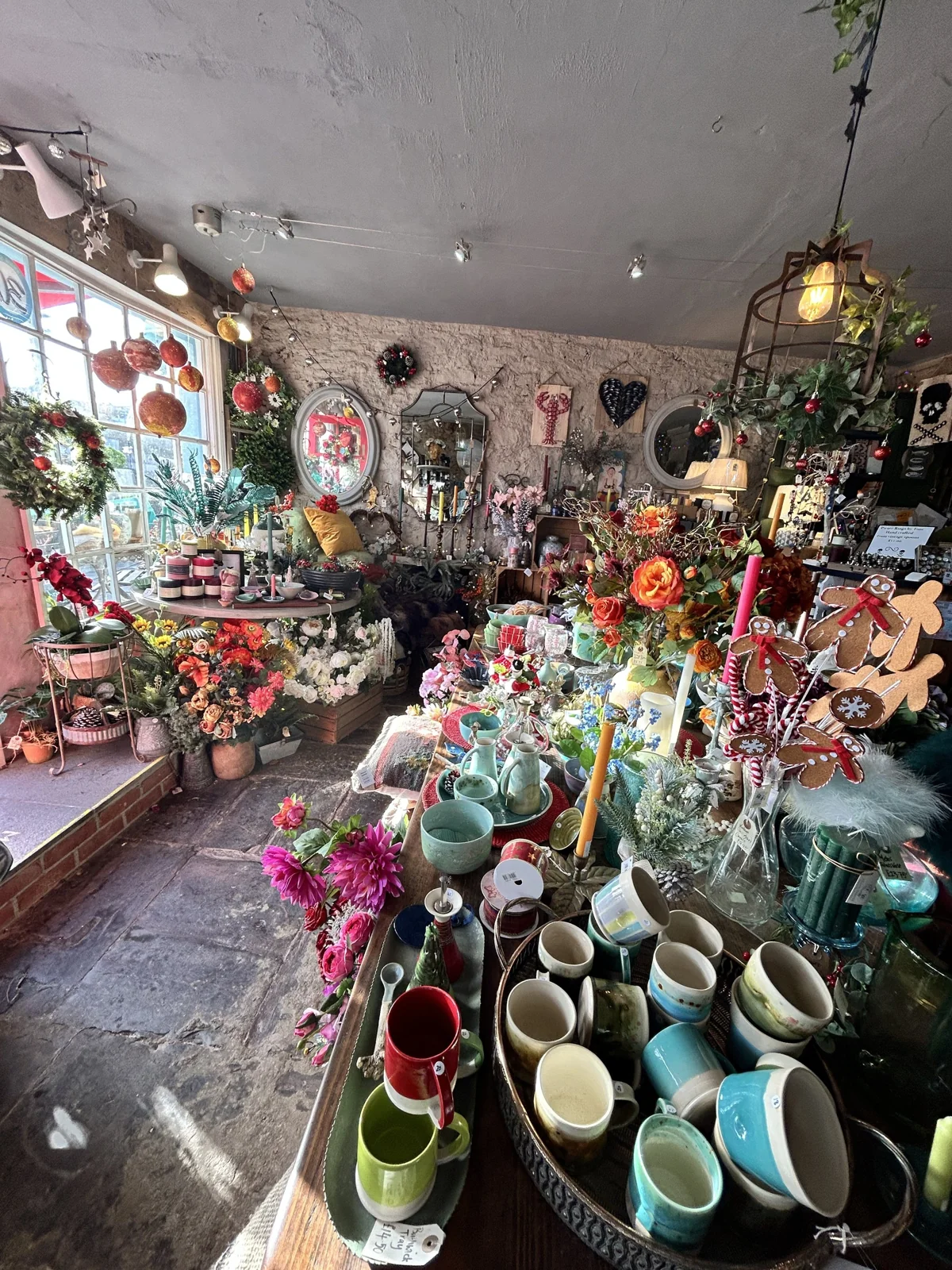 Shelves and tables of ceramics, flowers and homewares inside Flotsam 50