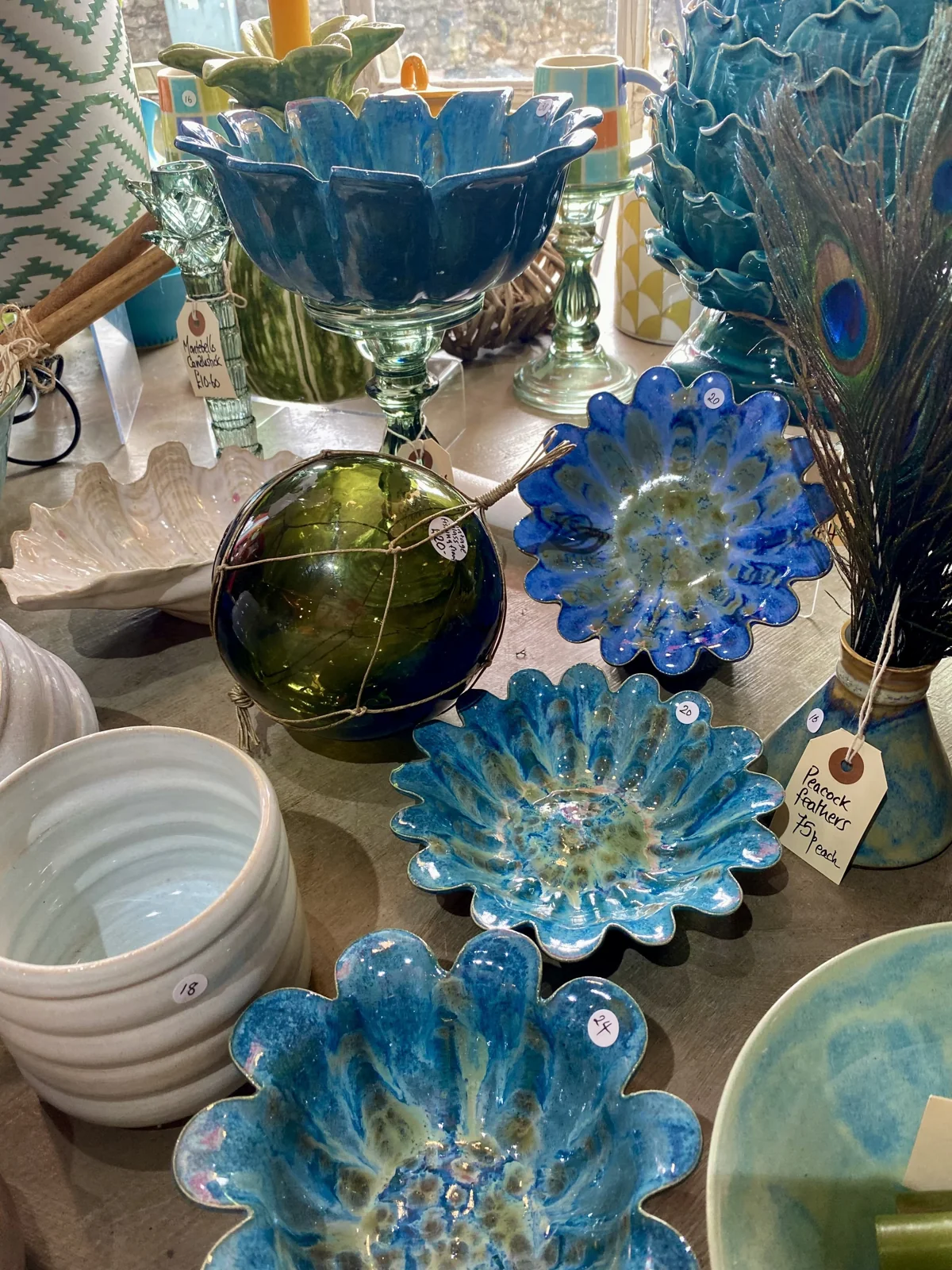 Blue and green ceramics and glassware on display