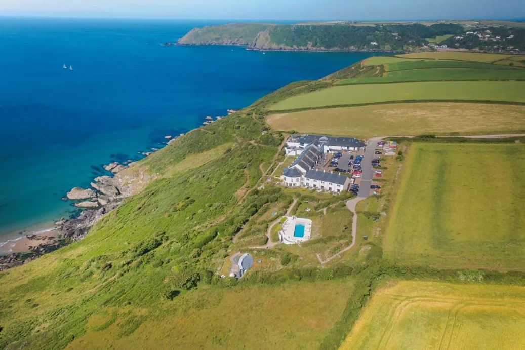 Aerial view of Gara Rock hotel beside fields and the sea