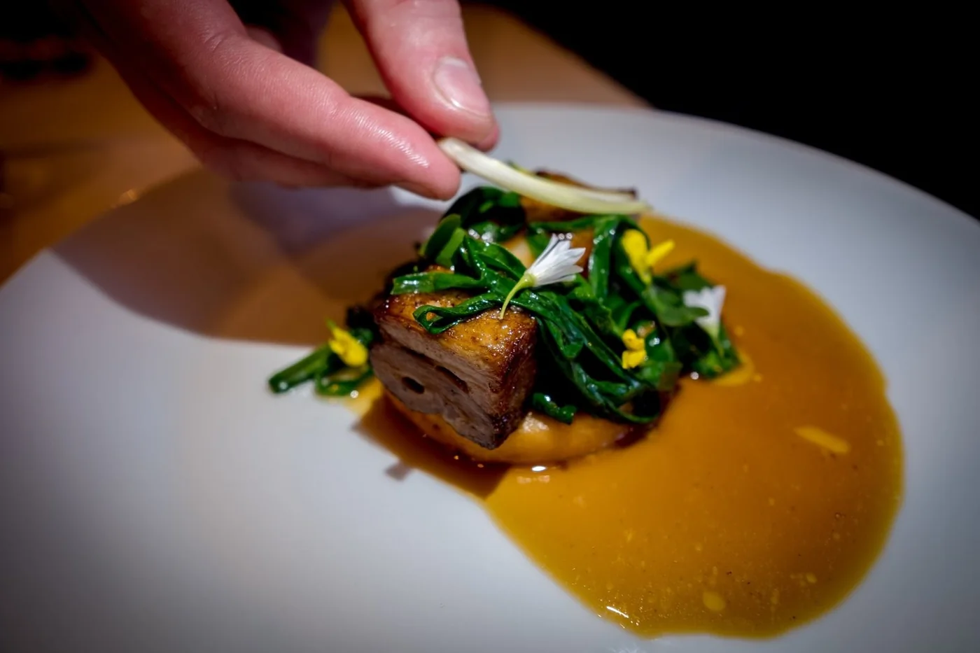A chef finishing a colourful dish at Gather