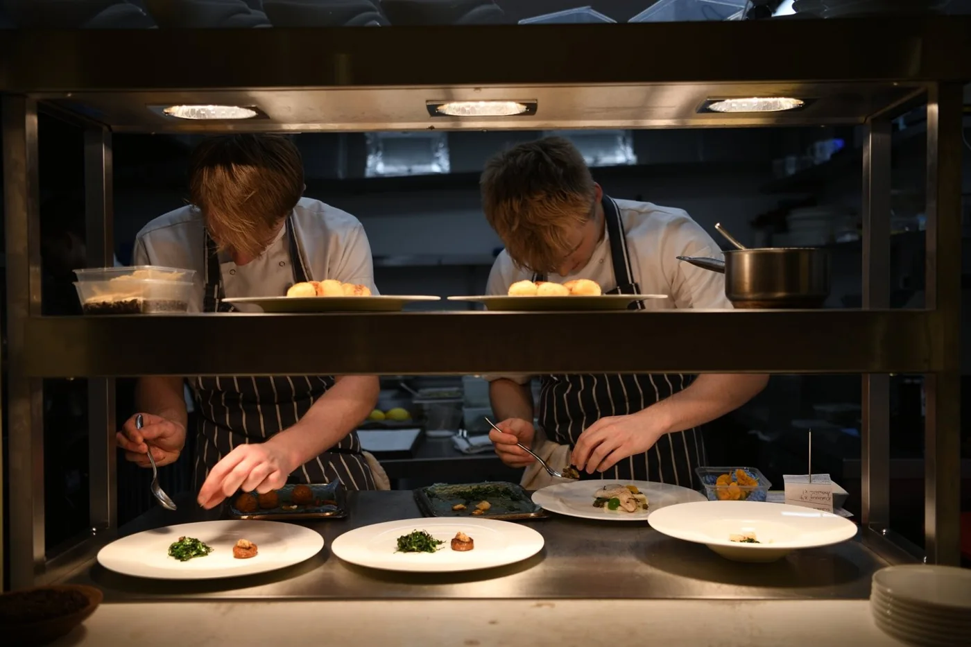 Chefs working at the pass in Gather’s kitchen