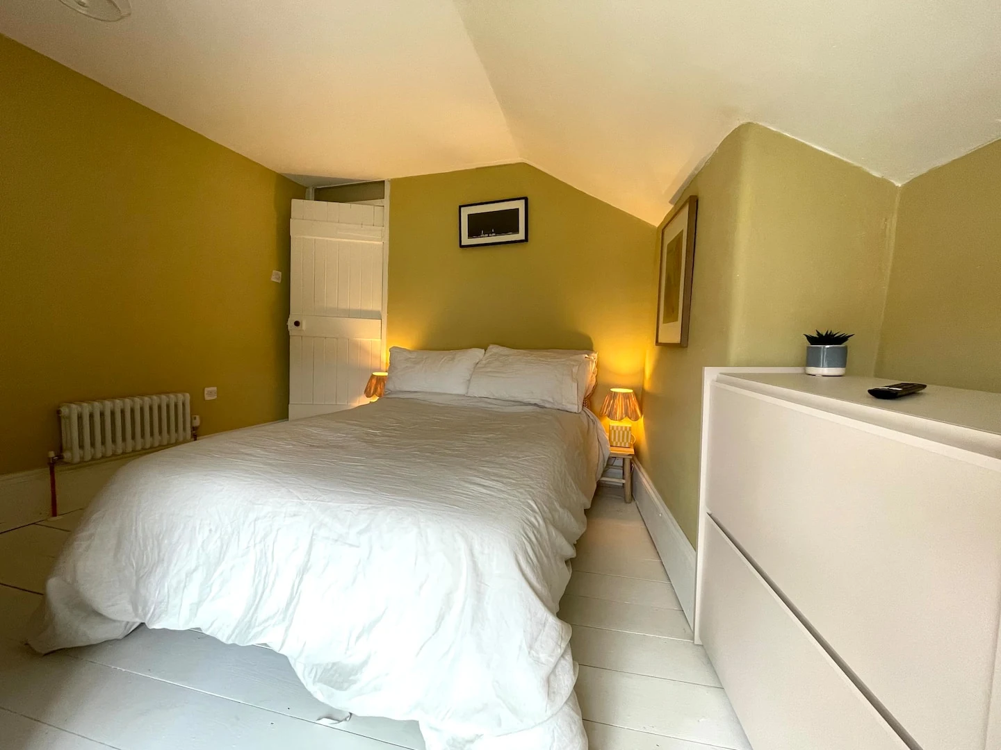 Bedroom with olive walls and white bedding
