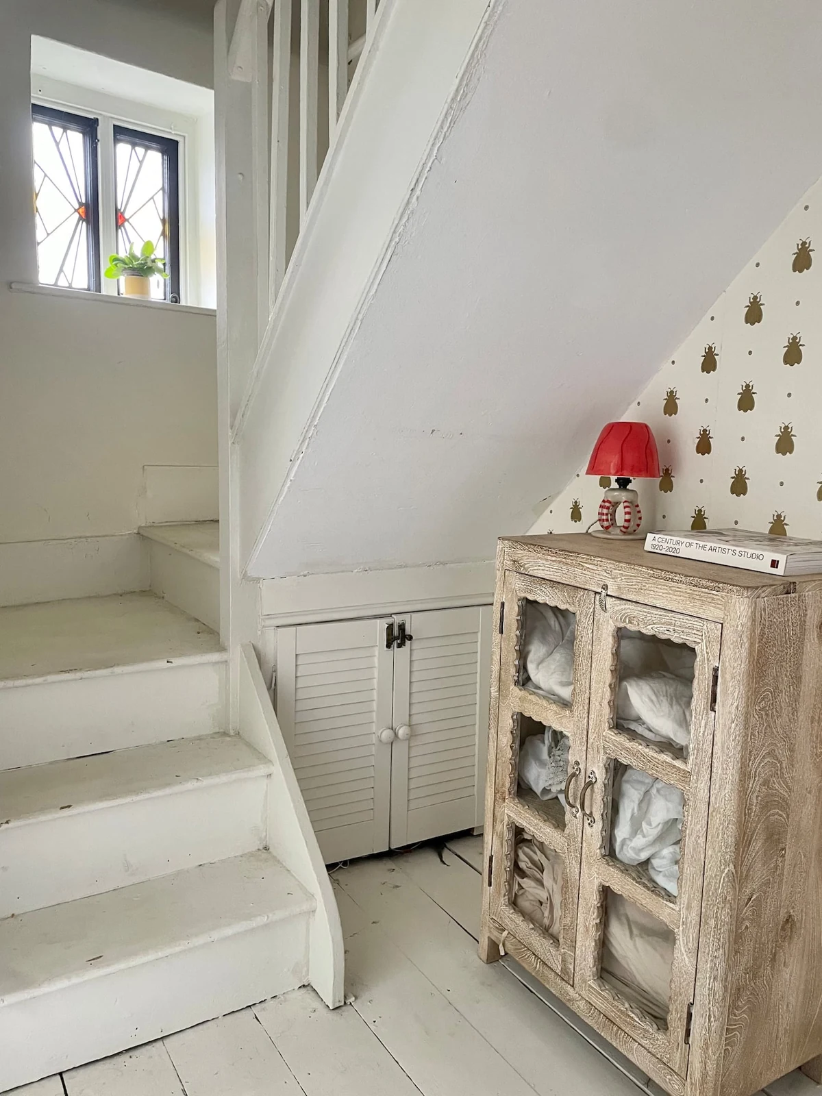 White staircase and stained-glass window