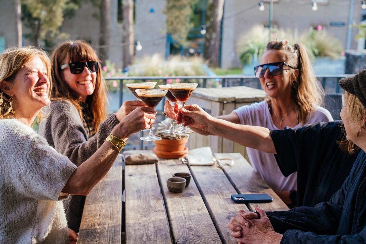 Guests raising glasses on The Green Table terrace