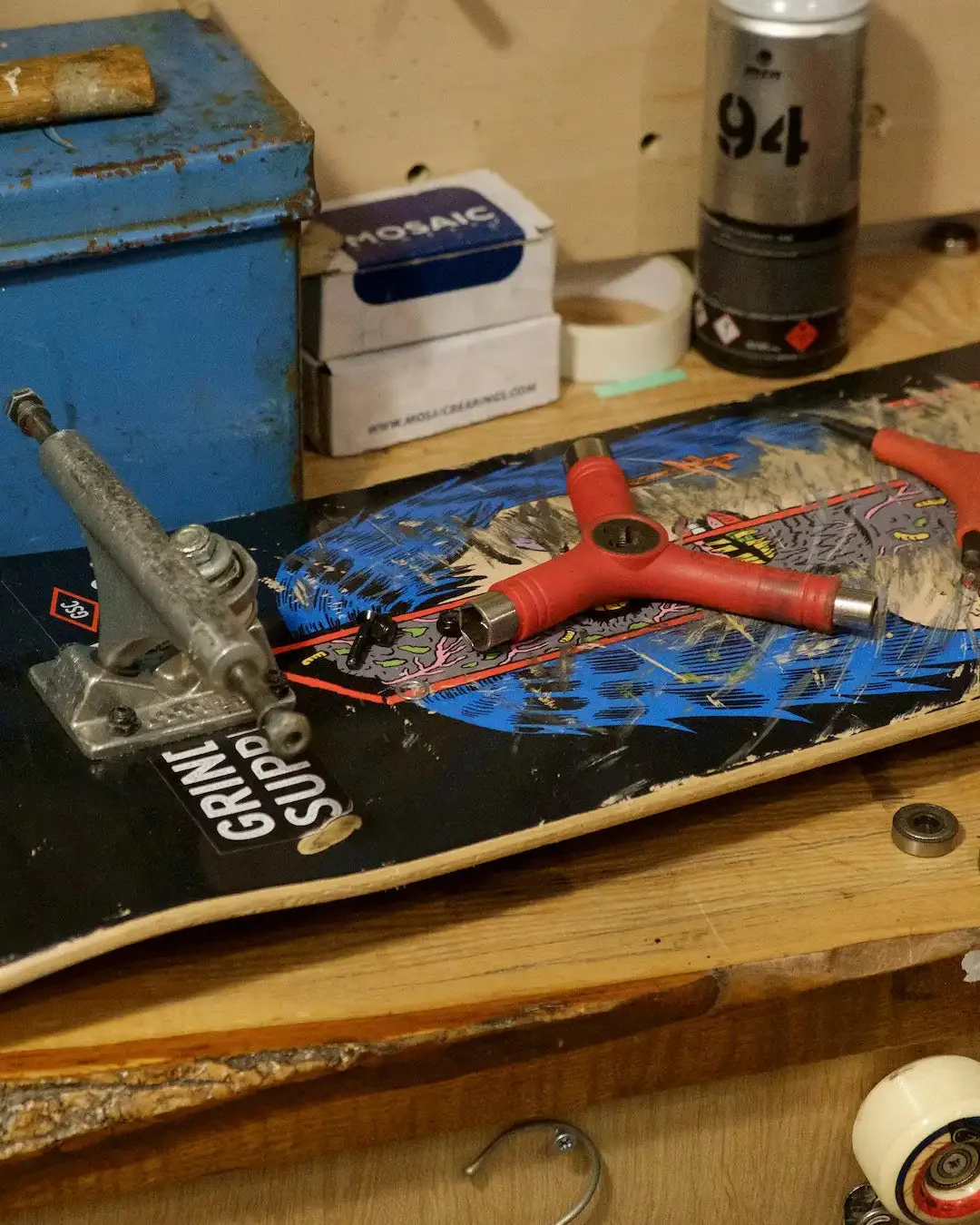 A skateboard and tools on a workbench at Grind Supply Co