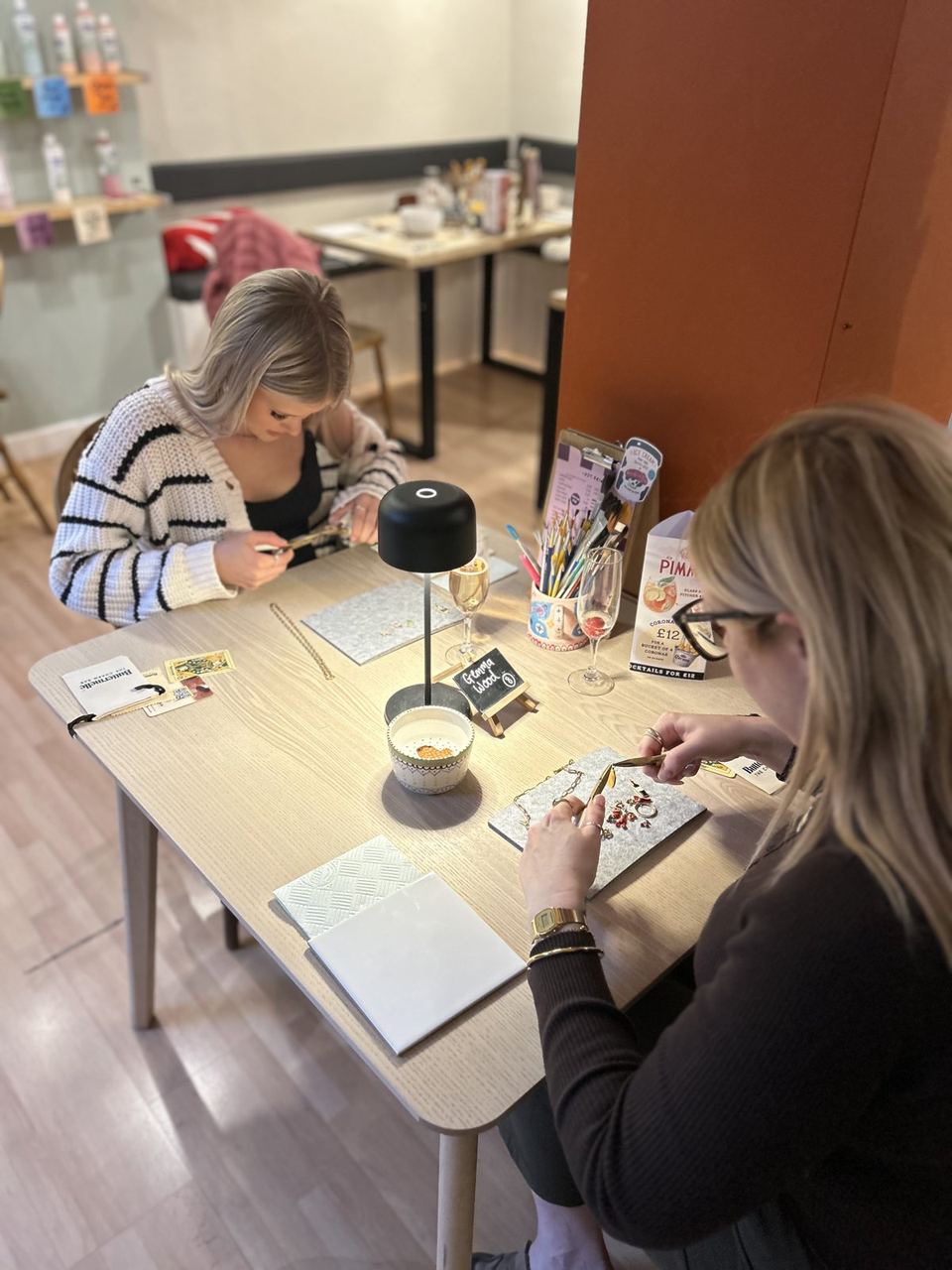 Visitors working on pottery at a studio table