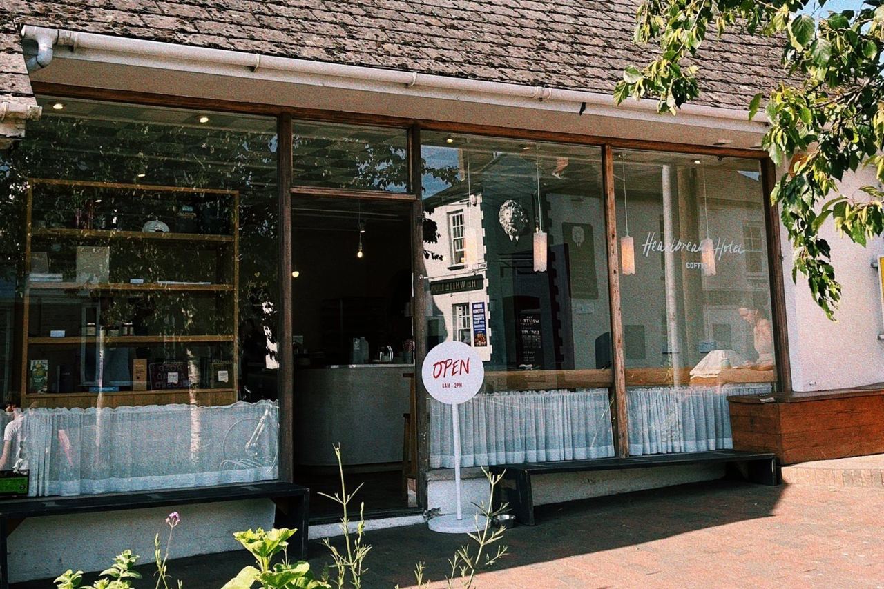 Broad windows and planting outside Heartbreak Hotel Coffee in Braunton