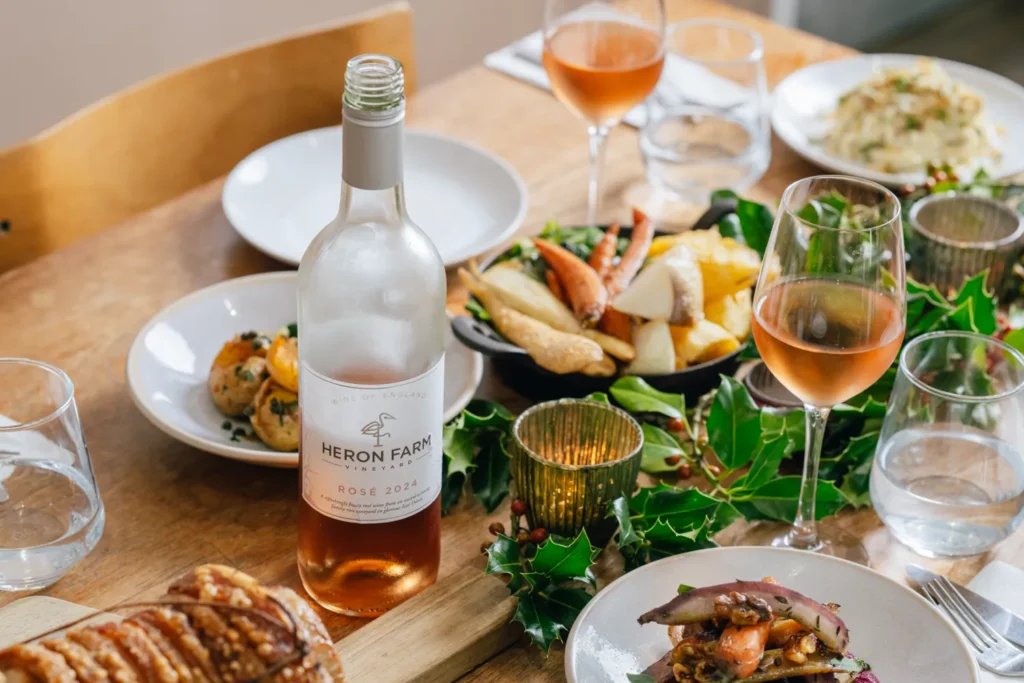 A seasonal lunch spread and Heron Farm rosé on a wooden table