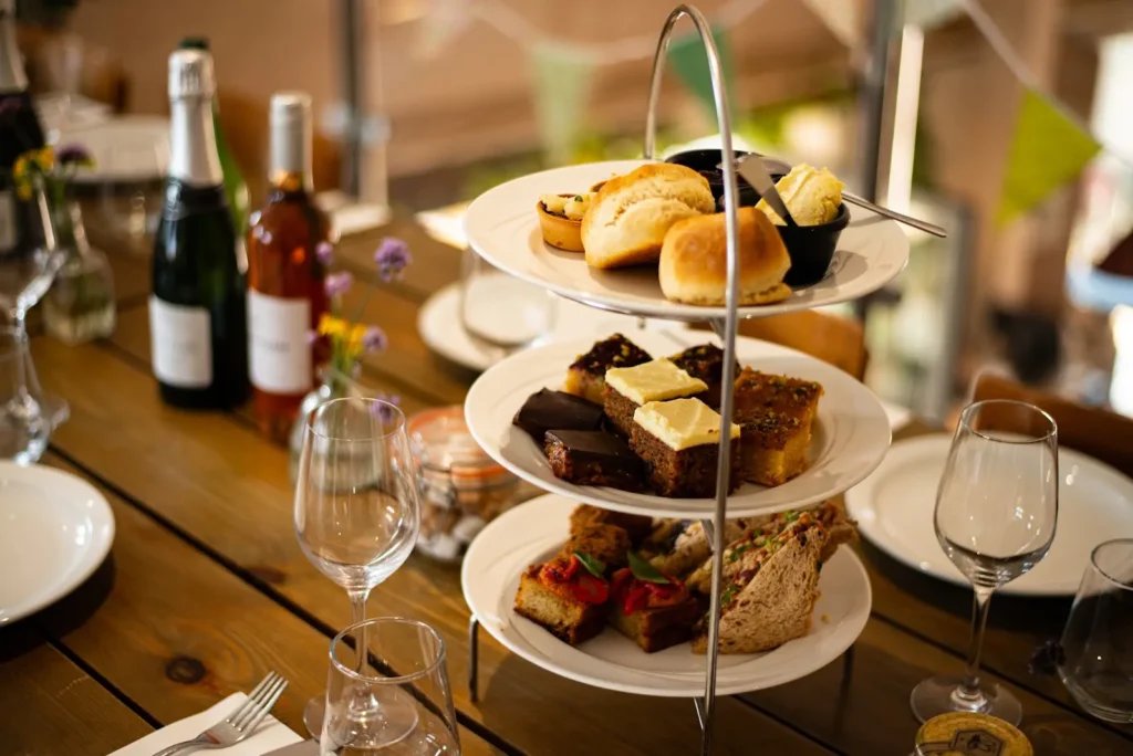 Tiered afternoon tea with scones, cakes and sandwiches at Heron Farm