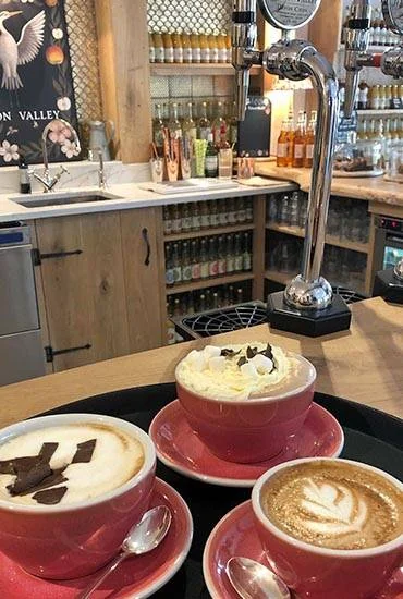 Cups of coffee on the café counter at Heron Valley