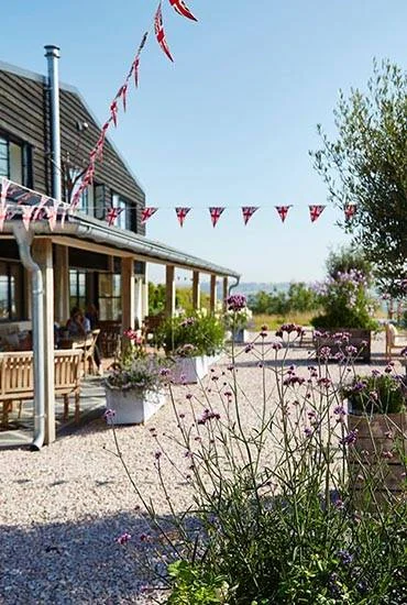 Bunting and planters along the Heron Valley café courtyard