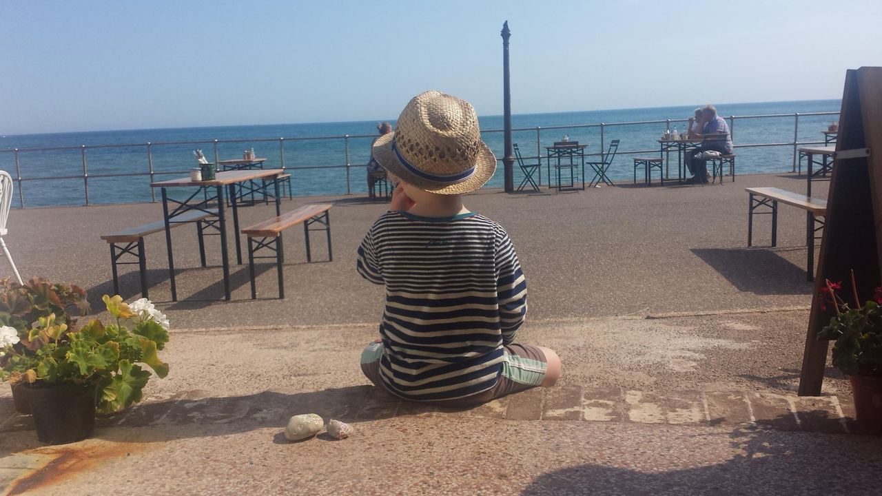 A guest looking out to sea from The Hideaway’s terrace