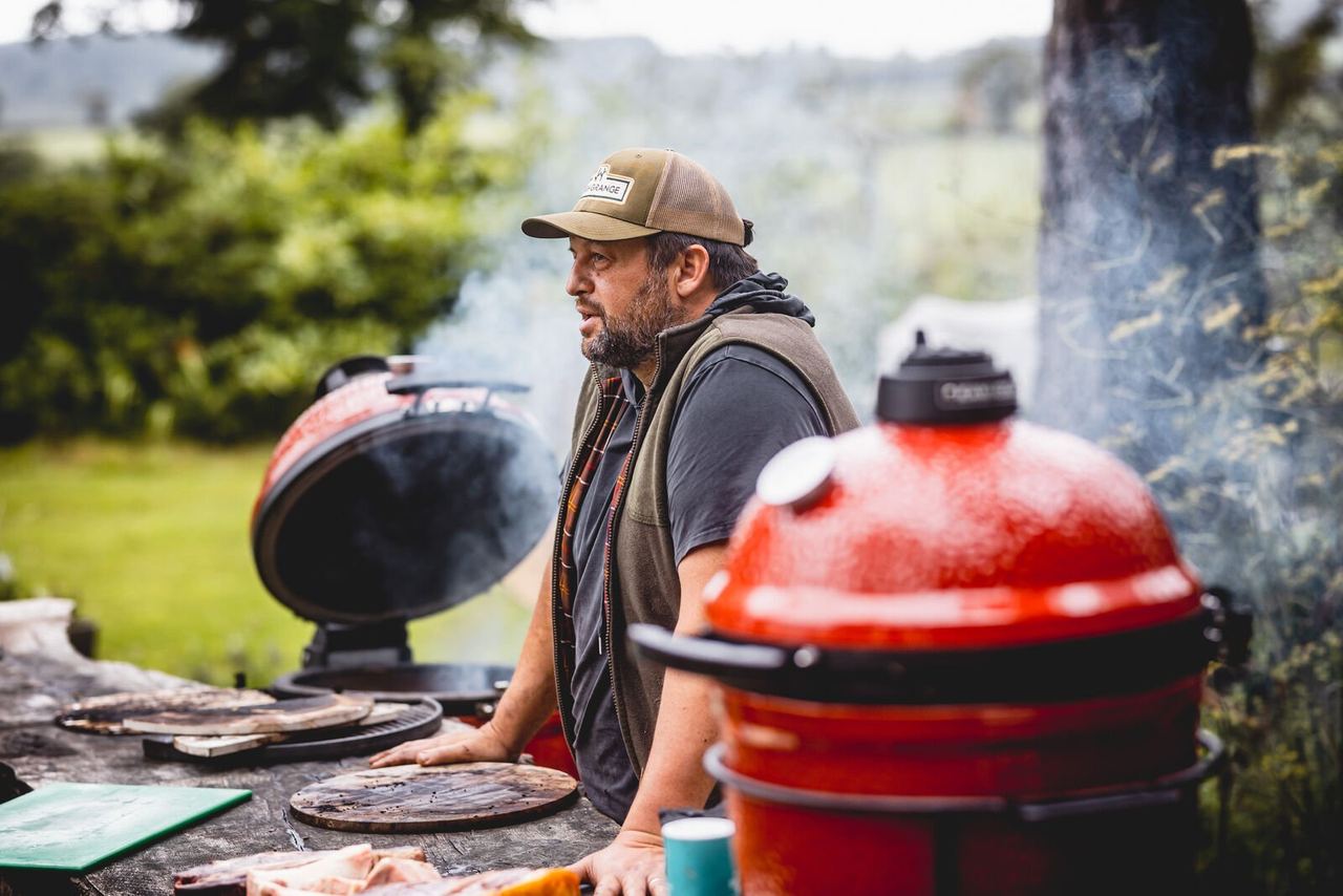 Cook tending ceramic barbecues in the High Grange woodland