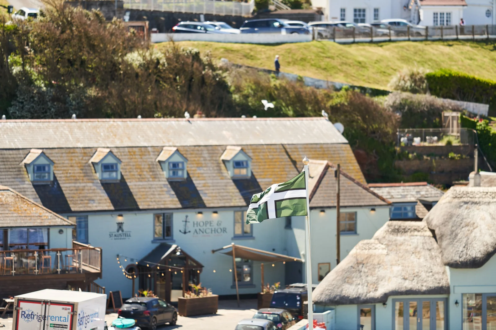 Hope & Anchor pub frontage nestled among buildings by Hope Cove