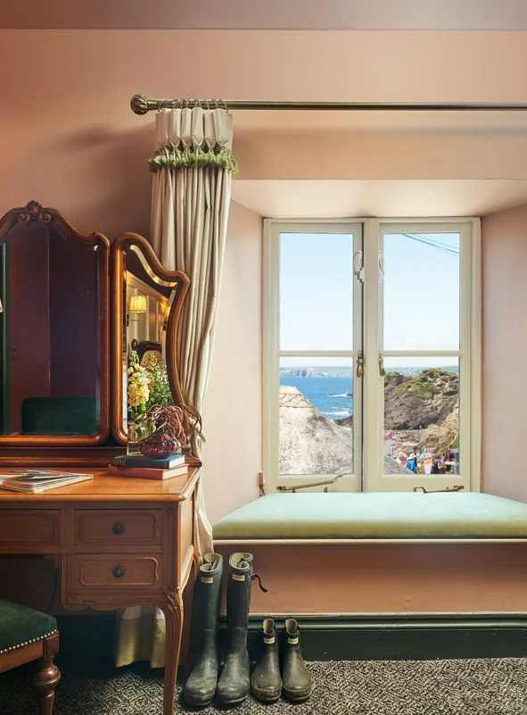 Window seat in a guest room looking towards the sea