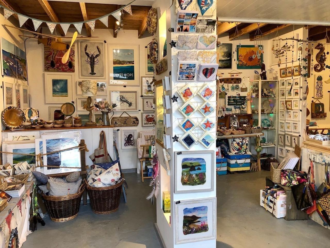 The open doorway and art-filled interior of Hope Cove Gallery