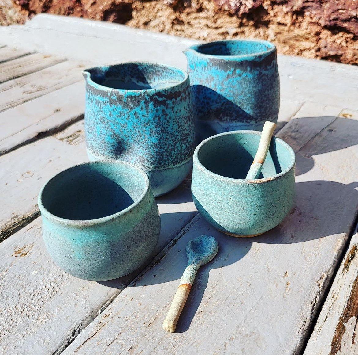 Blue glazed cups and vessels displayed at Hope Cove Gallery