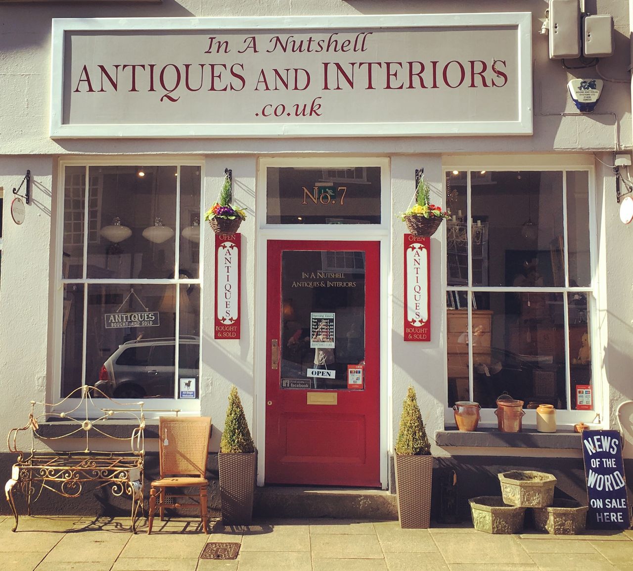The red door and traditional shopfront of In A Nutshell Antiques & Interiors on North Street