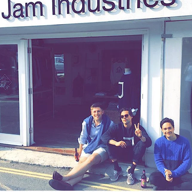Three people outside JAM Industries’ original Salcombe shop in an archive photograph