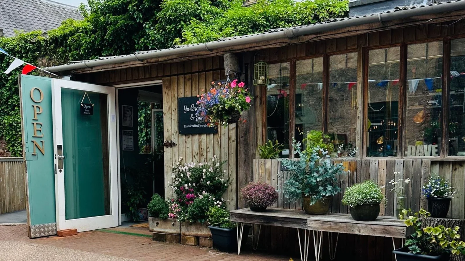 The flower-filled exterior of JOX Jewellery at Cockington Court