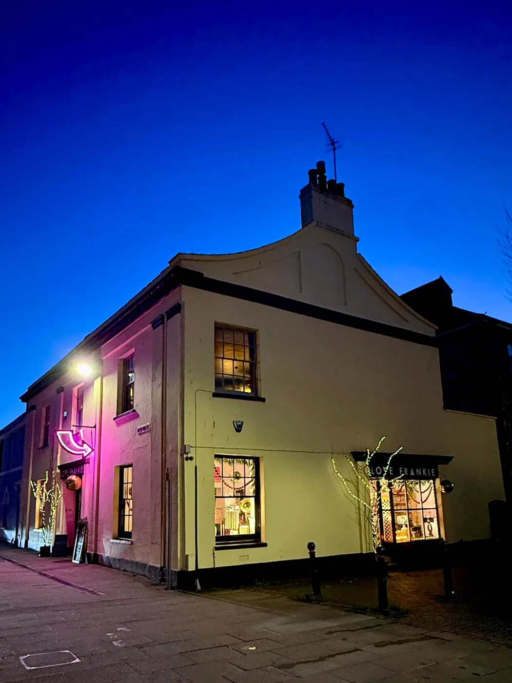 Love Frankie building glowing with coloured light at dusk