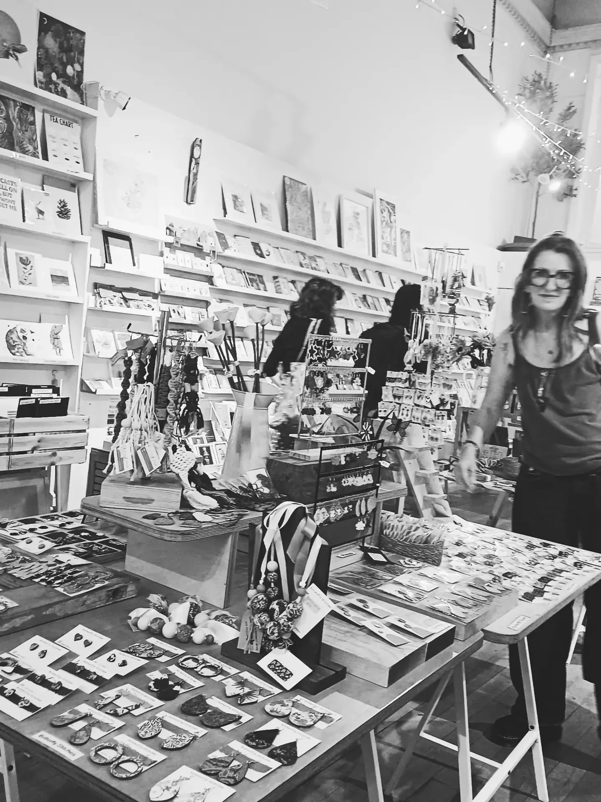 Black-and-white photograph of Maker Mart’s shop floor filled with cards and handmade goods