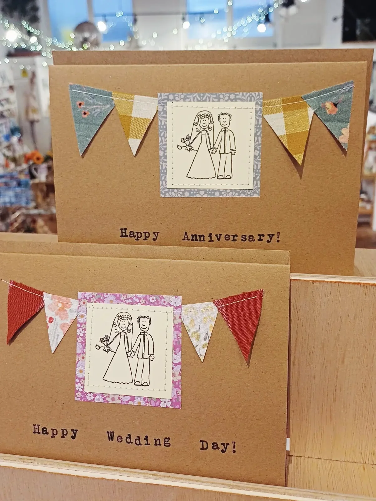 Illustrated celebration cards displayed inside Maker Mart