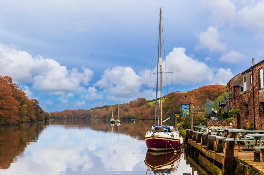 A moored sailing boat and waterside buildings at Tuckenhay