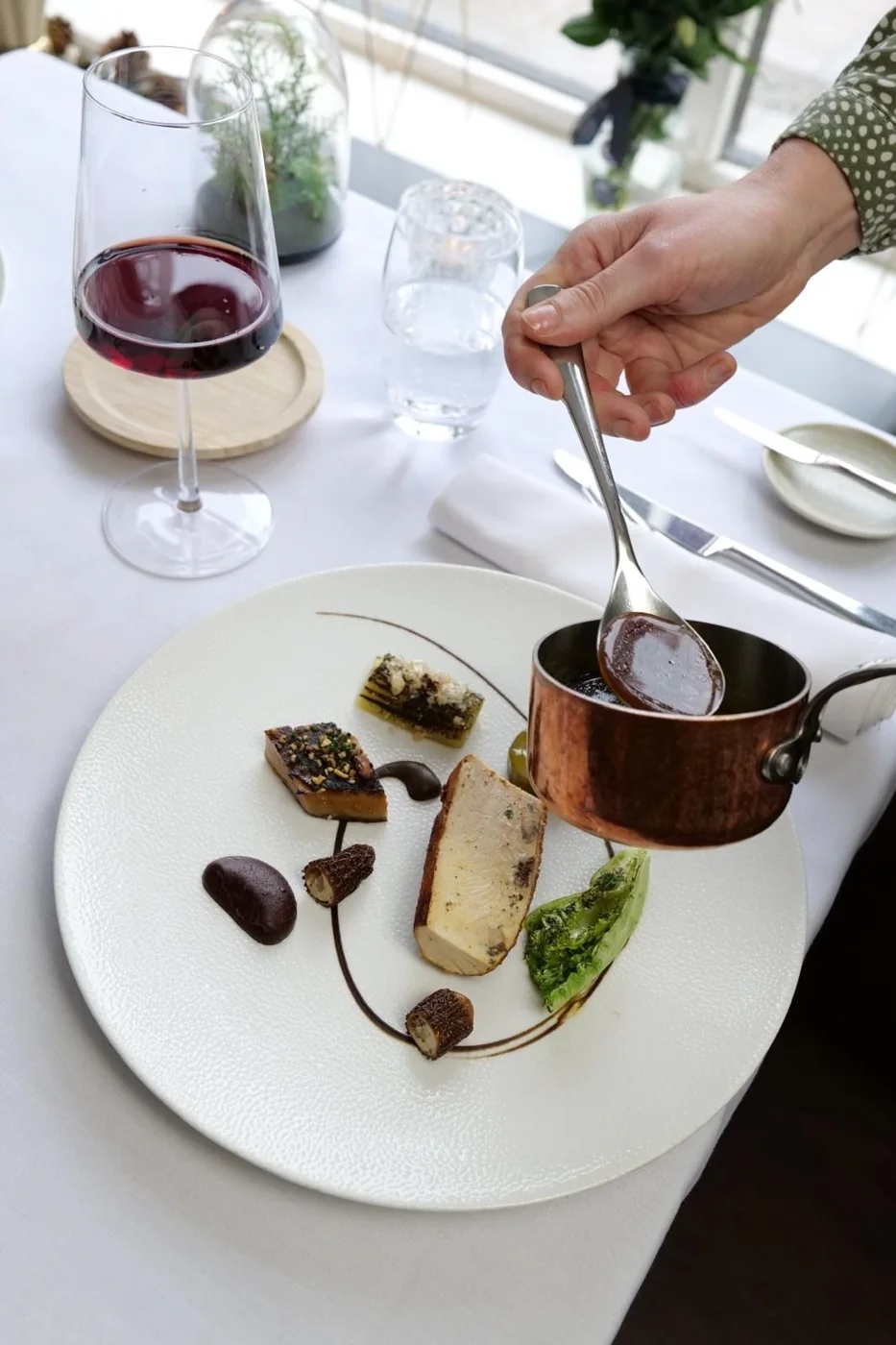 A restaurant dish being finished with sauce at The Maltsters Arms