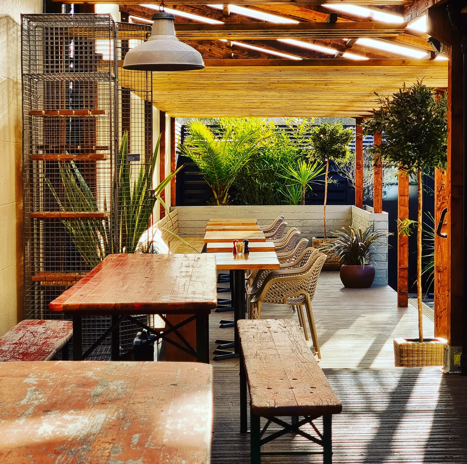 Tables in a covered outdoor seating area at Mangetout