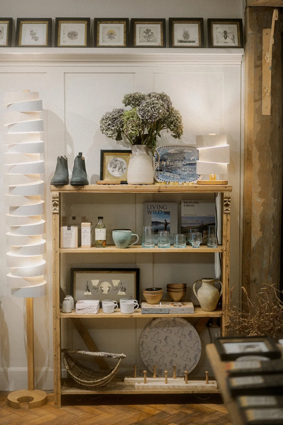Pale shelves of ceramics and gifts inside Me and East