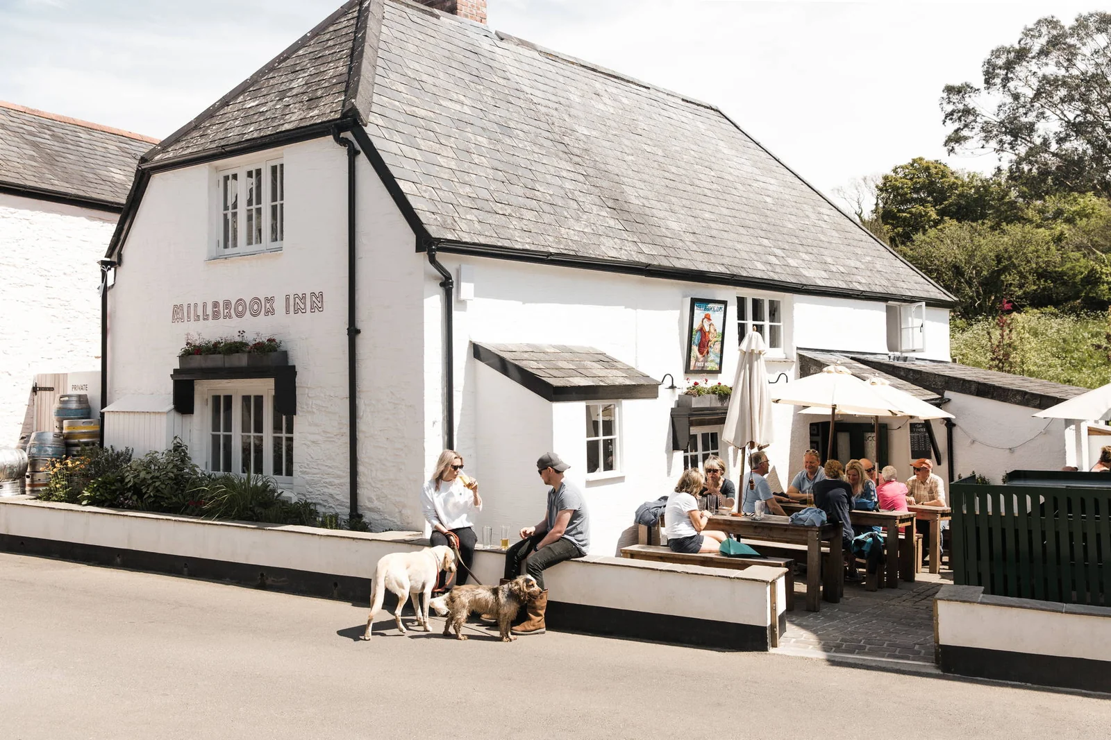 White-painted Millbrook Inn with tables outside in South Pool