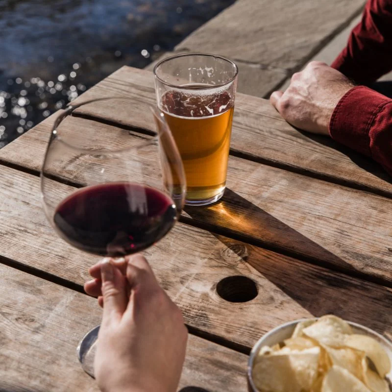 Wine and beer on an outdoor wooden table