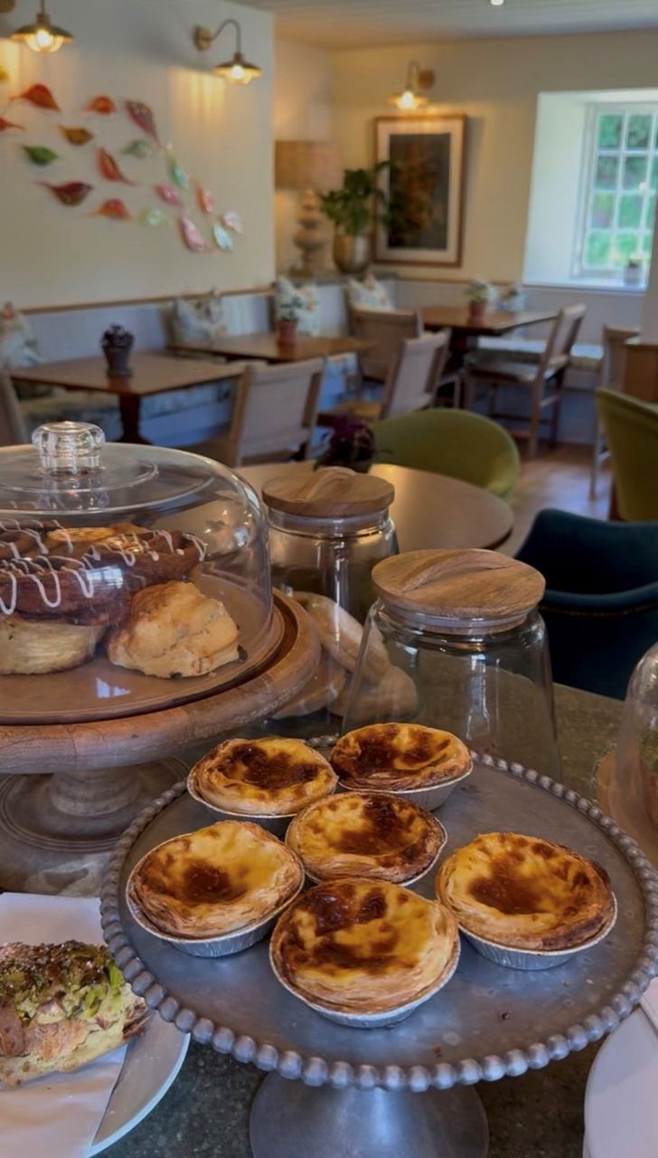 Cakes under glass beside the tables at Miller’s