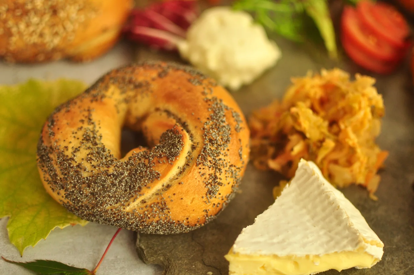 A seeded bagel served with accompaniments
