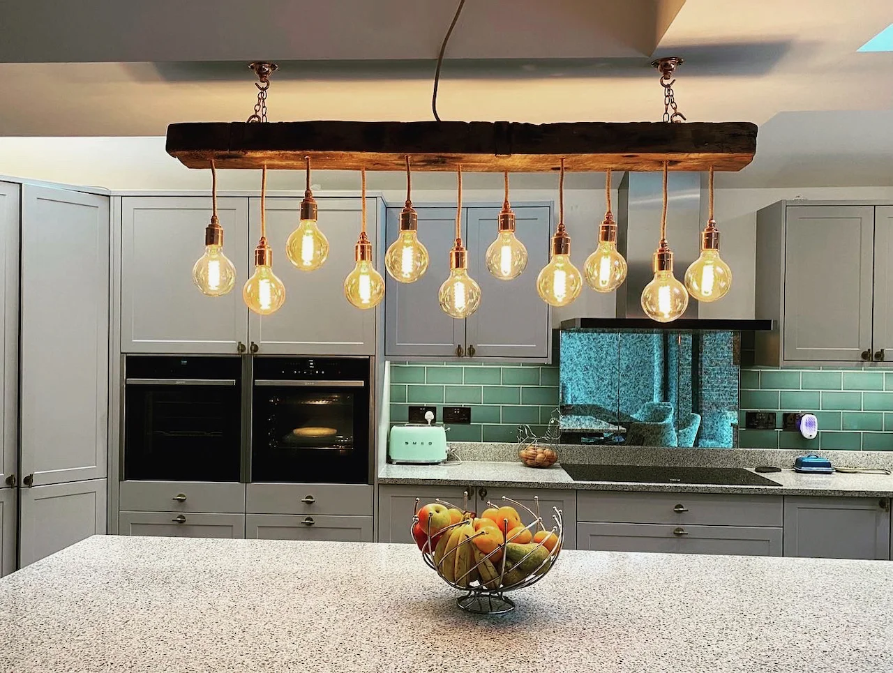 A MooBoo timber beam chandelier installed above a kitchen island