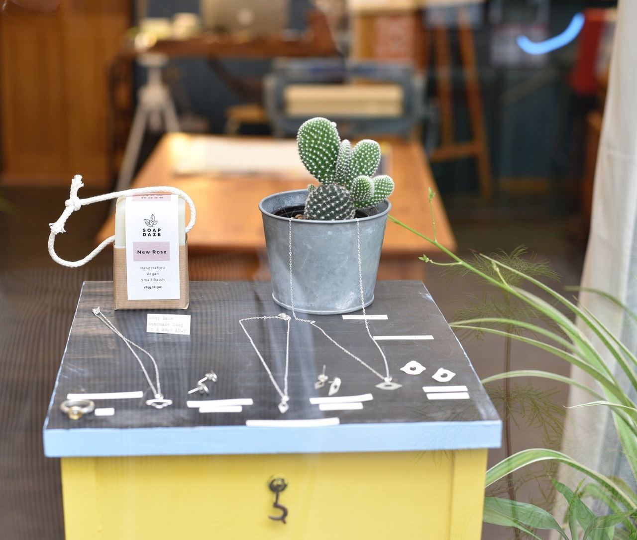 A cactus and jewellery display near the gallery entrance
