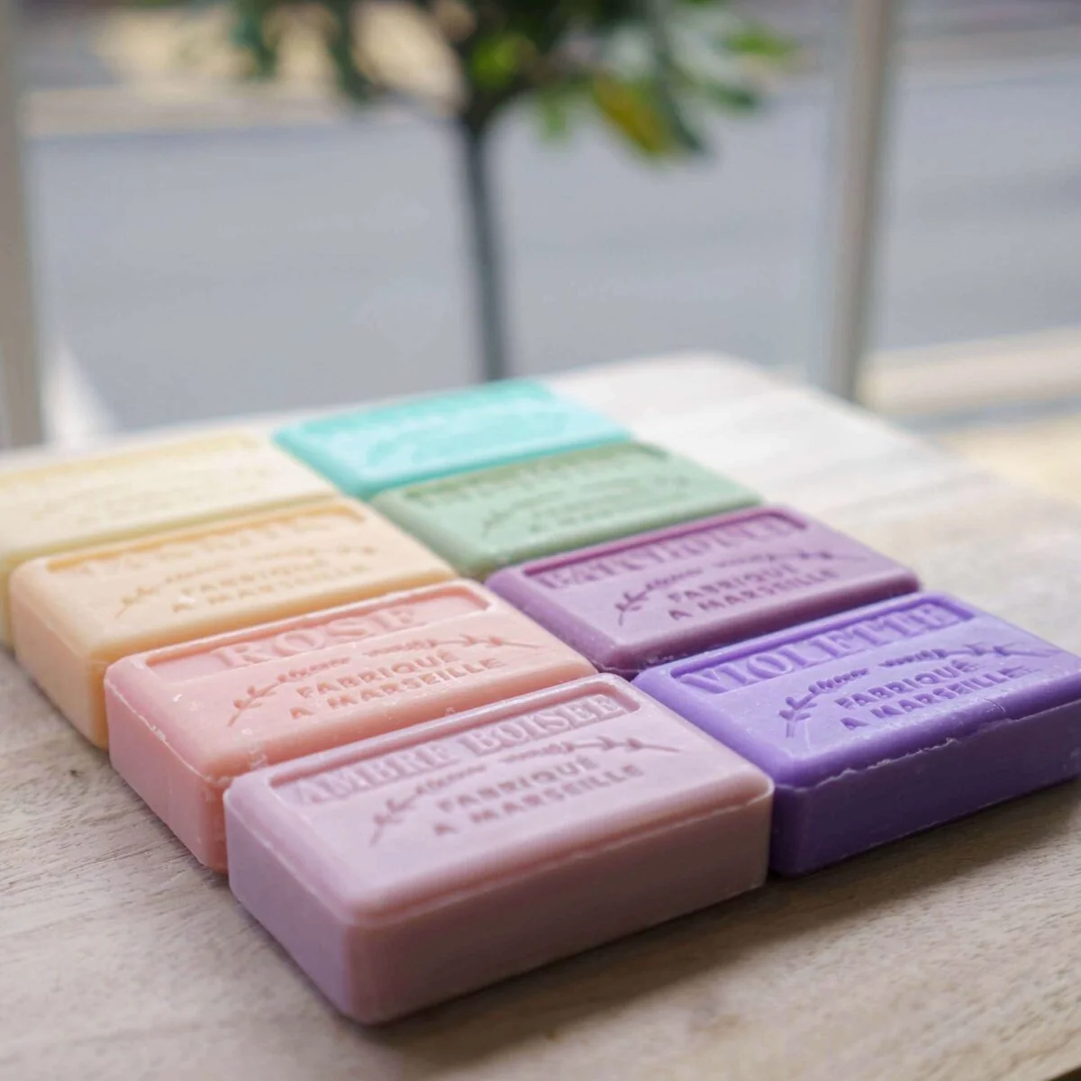 Pastel-coloured soap bars arranged in rows