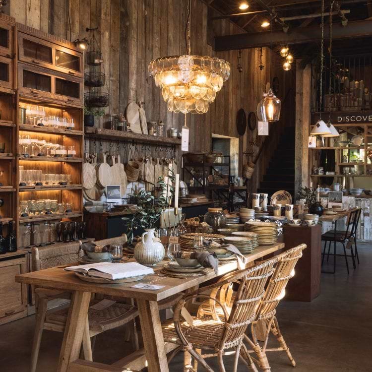 A table of homewares beneath pendant lights in Nkuku’s store