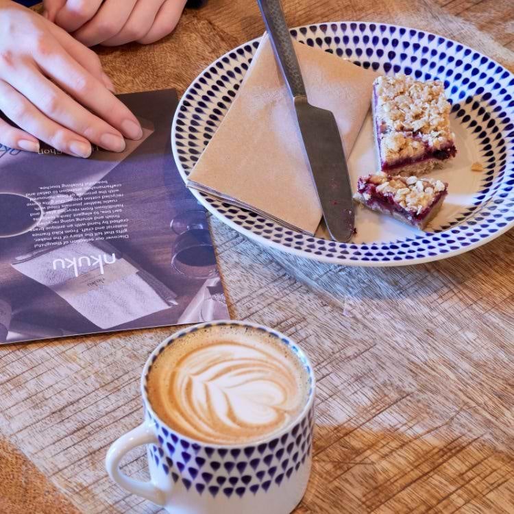 Coffee and cake on patterned crockery at Nkuku Café