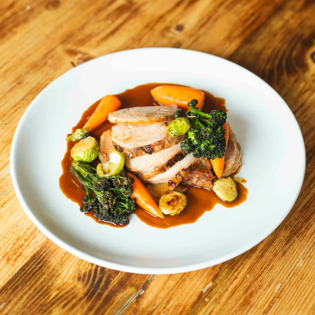 Roast meat and vegetables plated at Nomad Larder