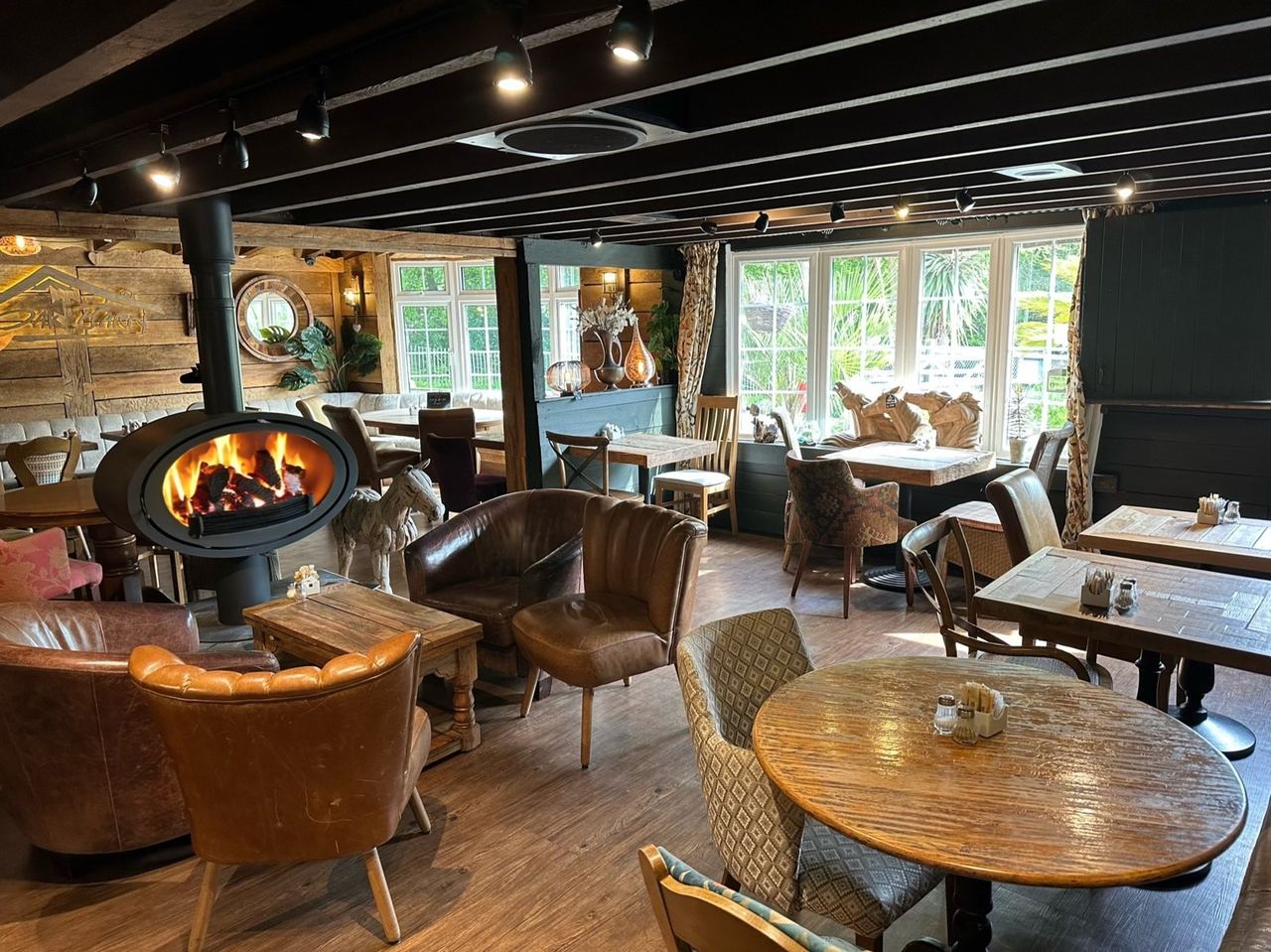 Wood burner and comfortable seating inside Oak Barn Coffee Lounge