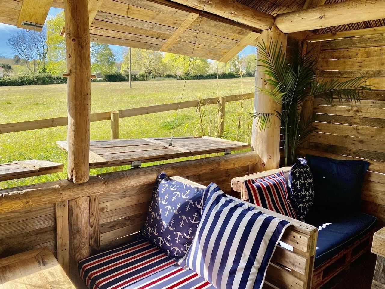 Covered timber seating overlooking countryside at Oak Barn