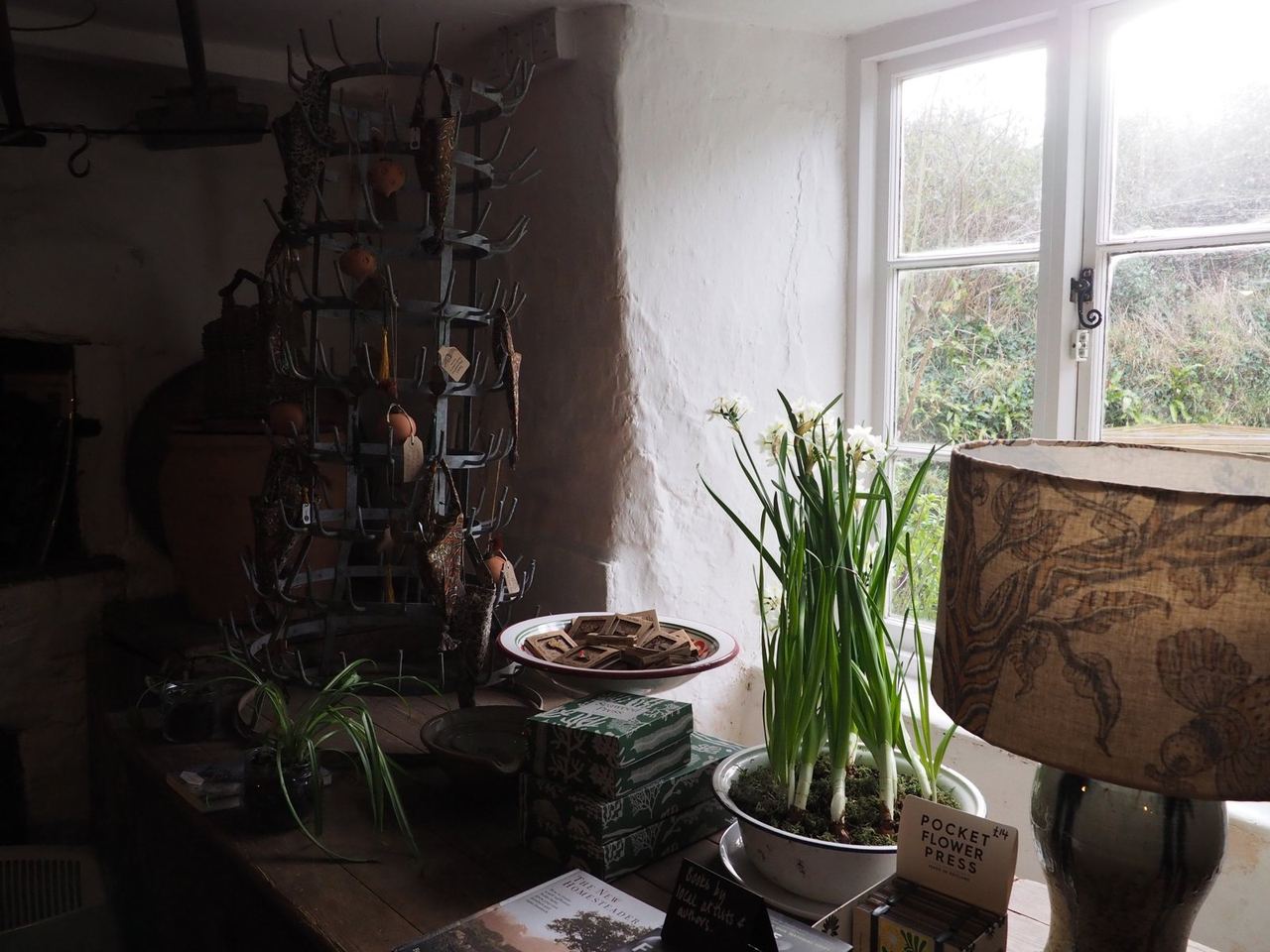 Craft display and spring flowers beside an Old Bakery window