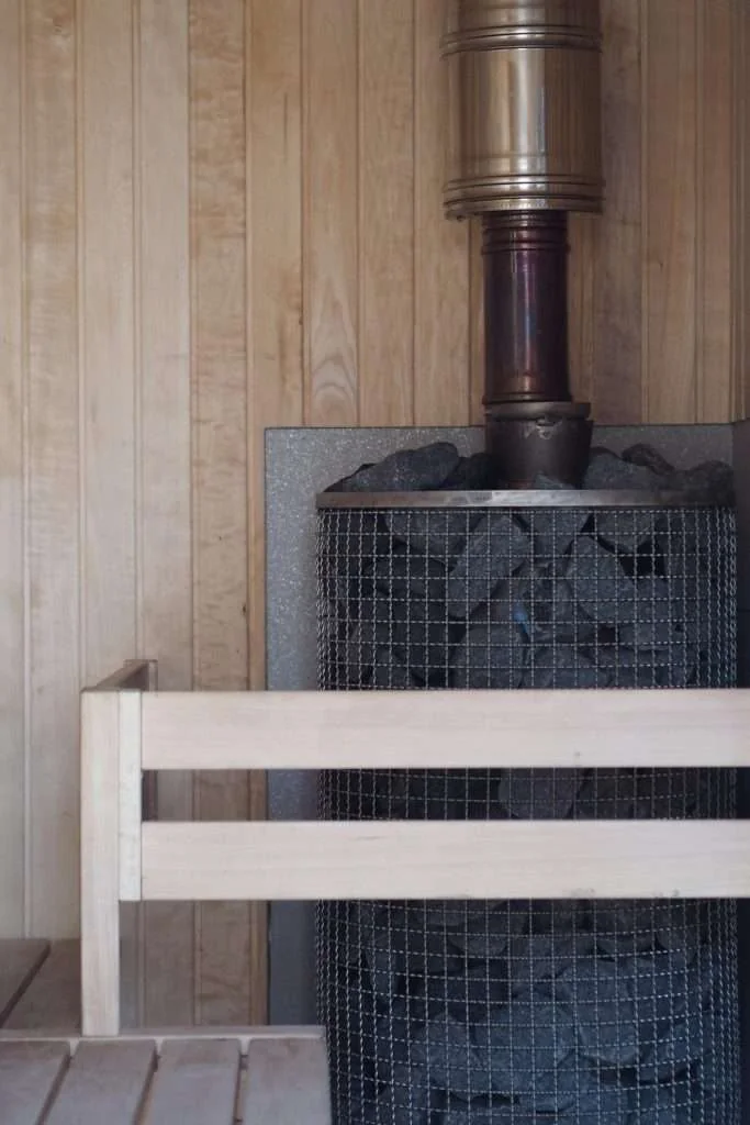 Wooden sauna interior with a stove and benches